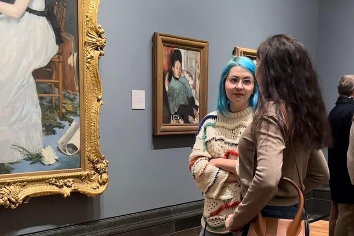 two women standing in a museum looking at art