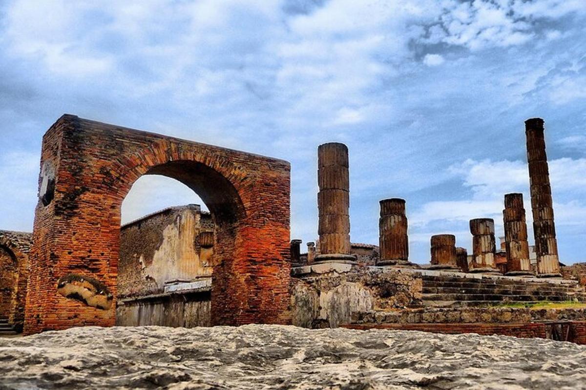 an old brick building with an arch in front