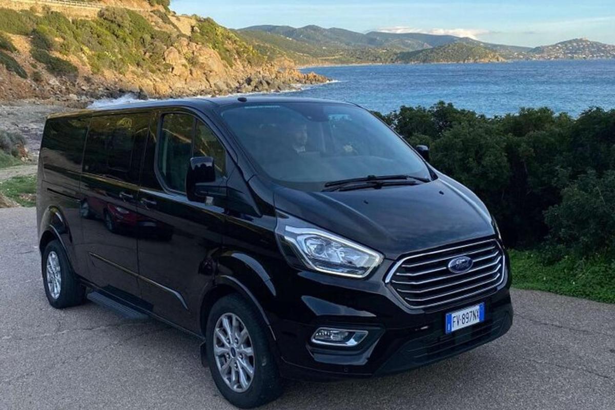 a black van parked next to a body of water