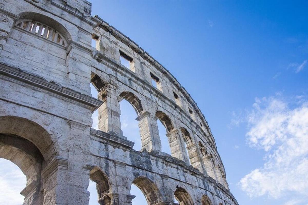 a building with arches in front of a blue sky
