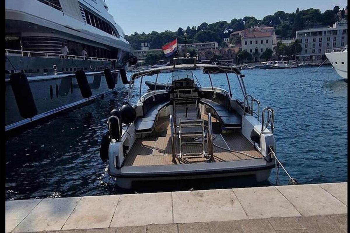a boat is docked next to a cruise ship