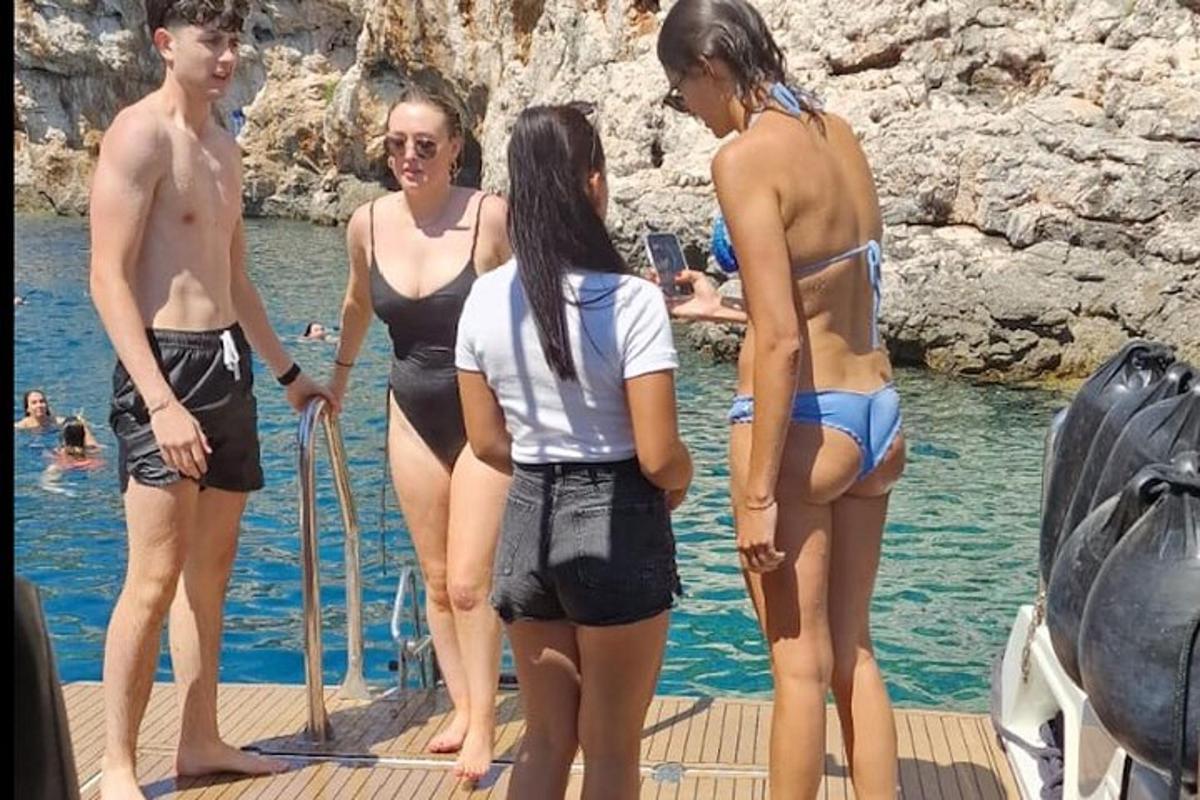 a group of people standing on a dock in the water