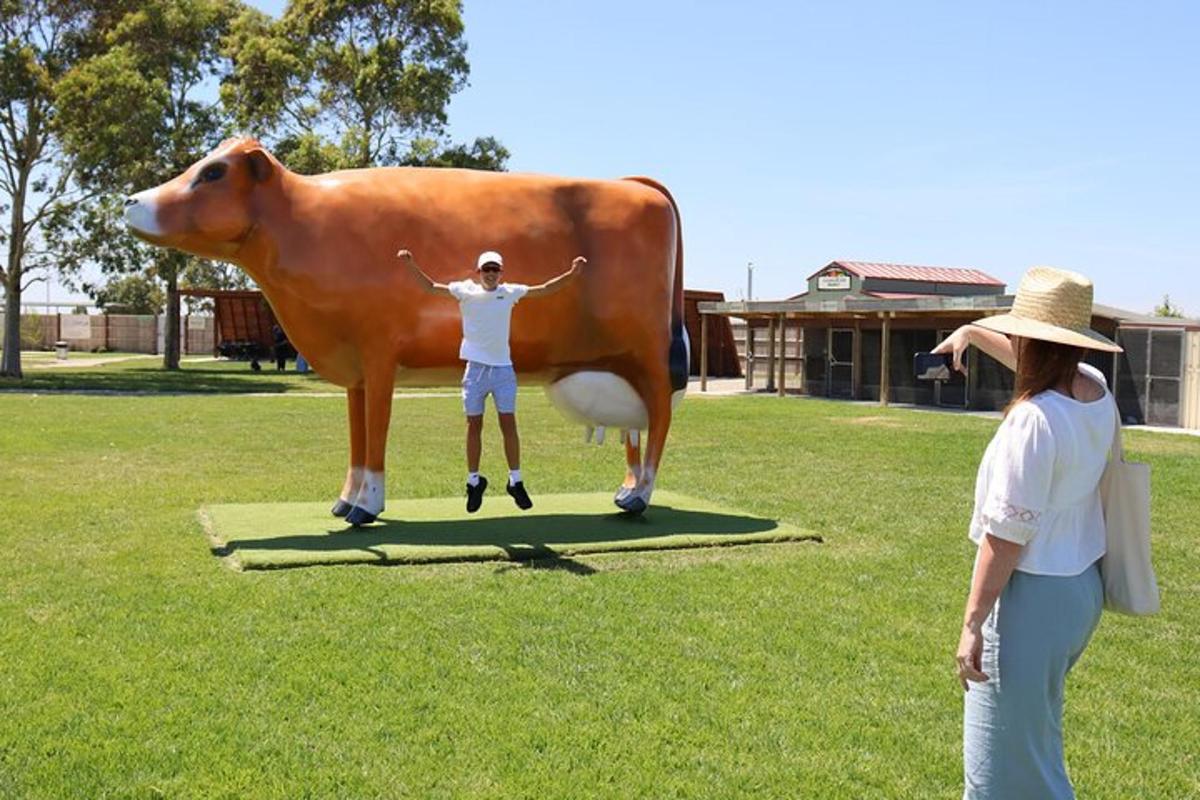 a woman standing next to a statue of a cow