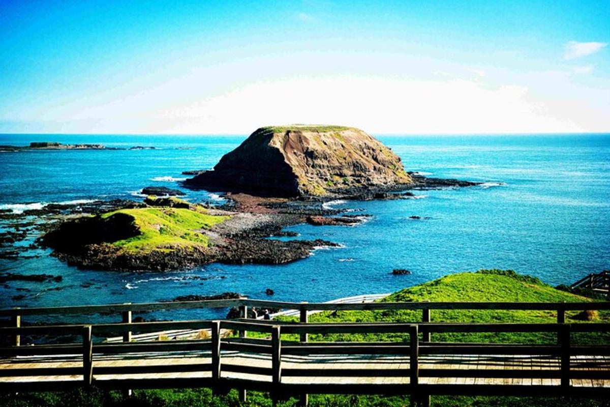 an island in the ocean with a wooden fence