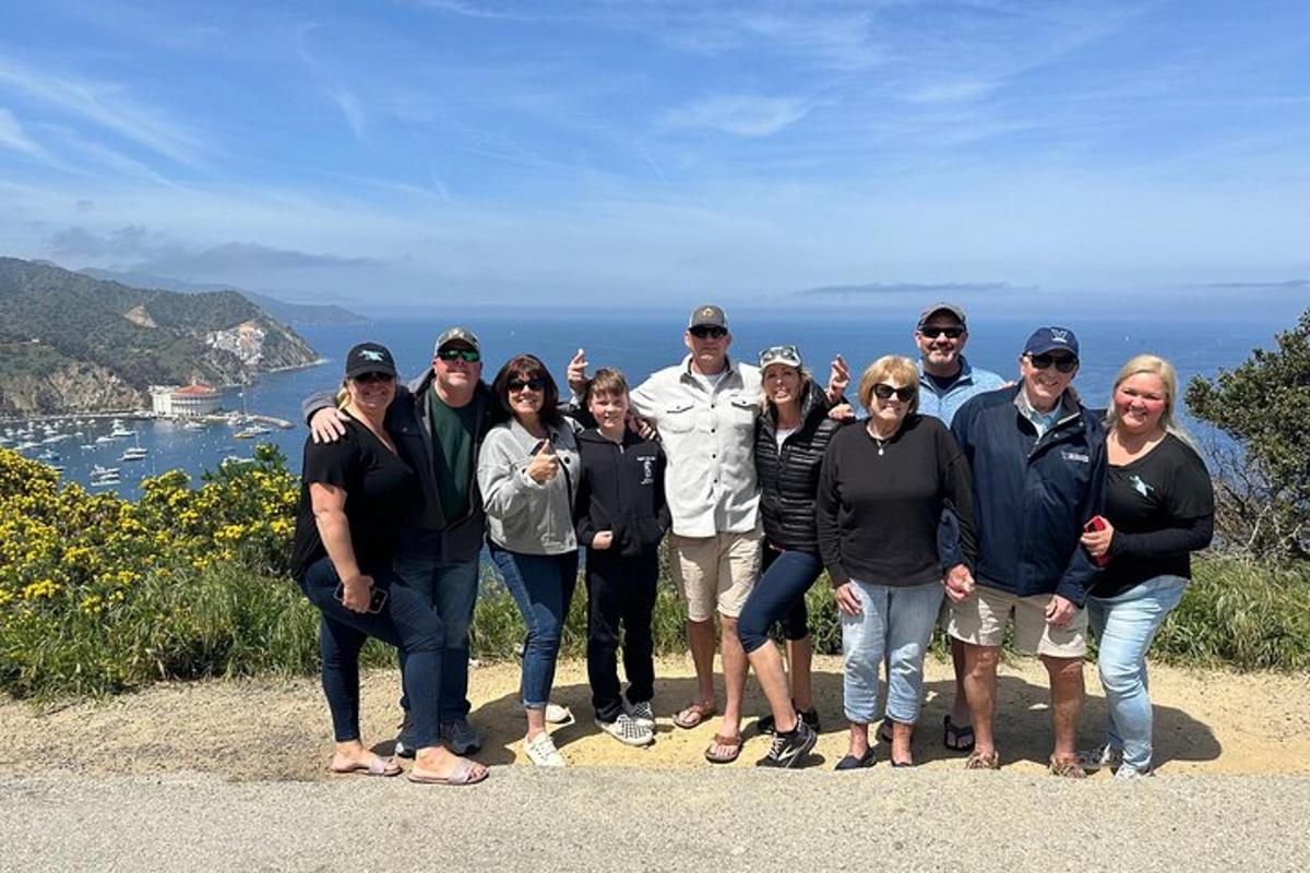 a group of people posing for a picture on a mountain