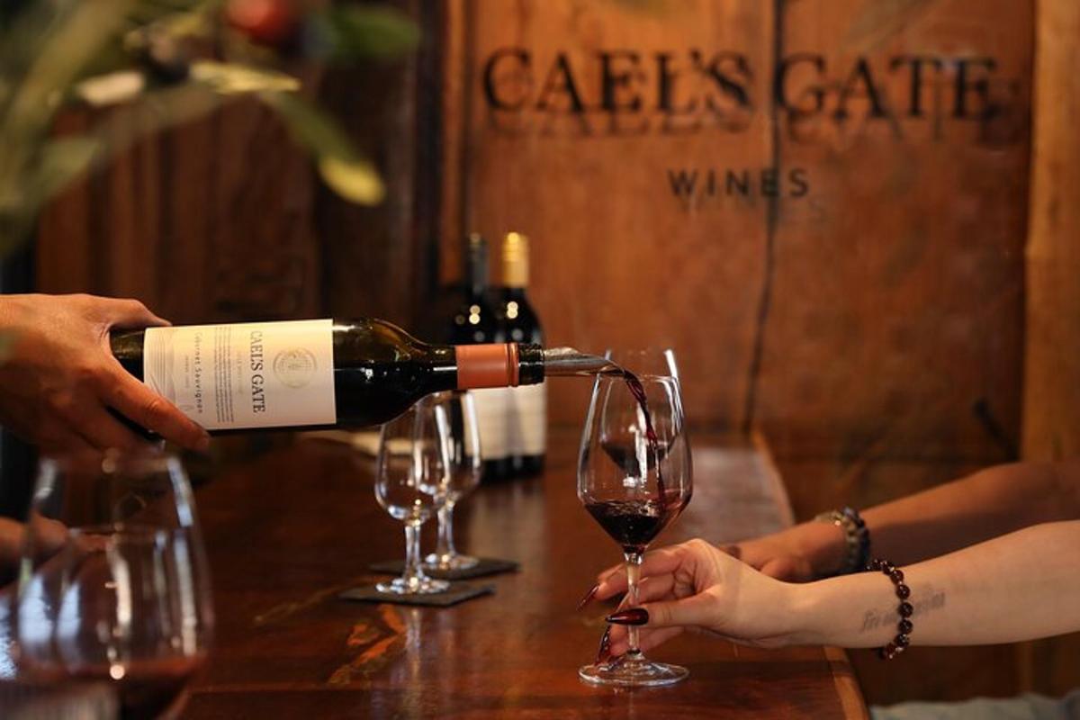 a person pouring a glass of wine on a table