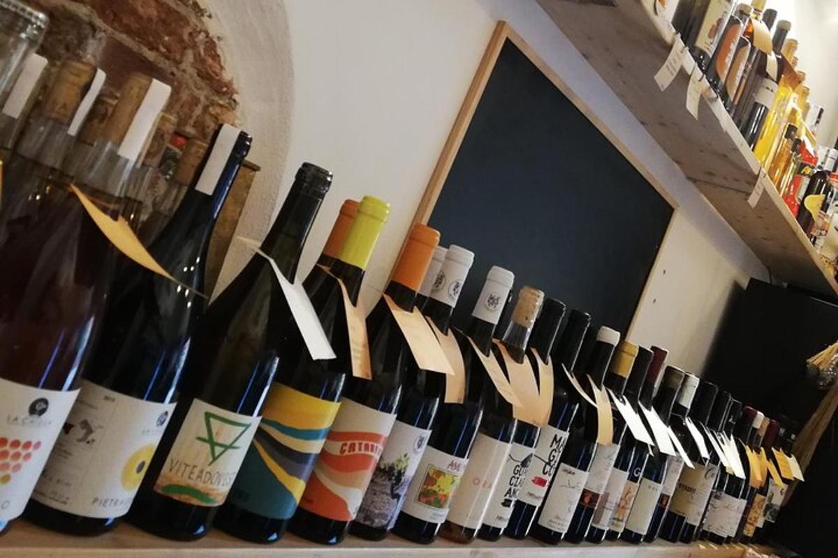 a bunch of wine bottles are lined up on a shelf