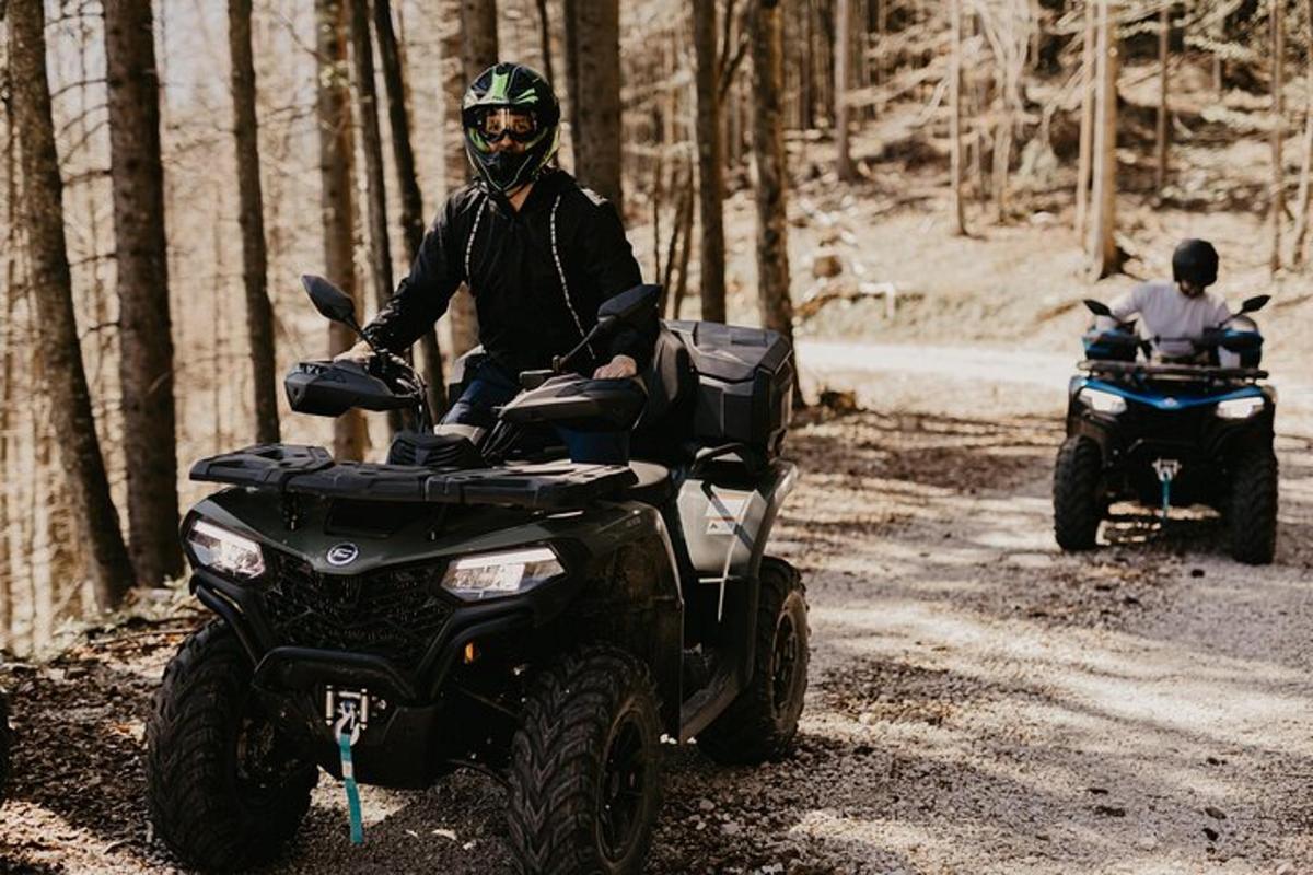 a man on a four wheeler on a dirt road