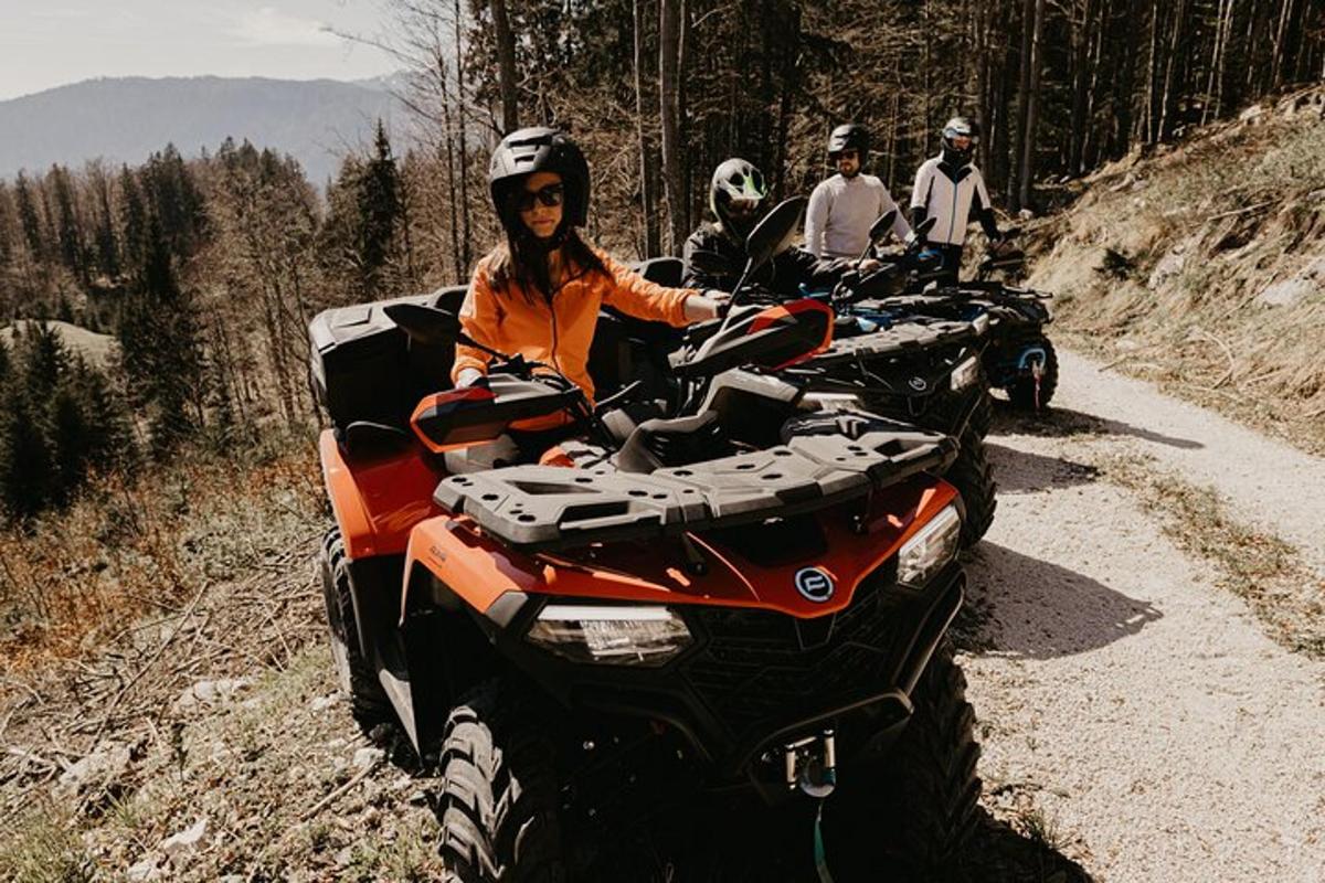 a group of people riding atvs on a dirt road