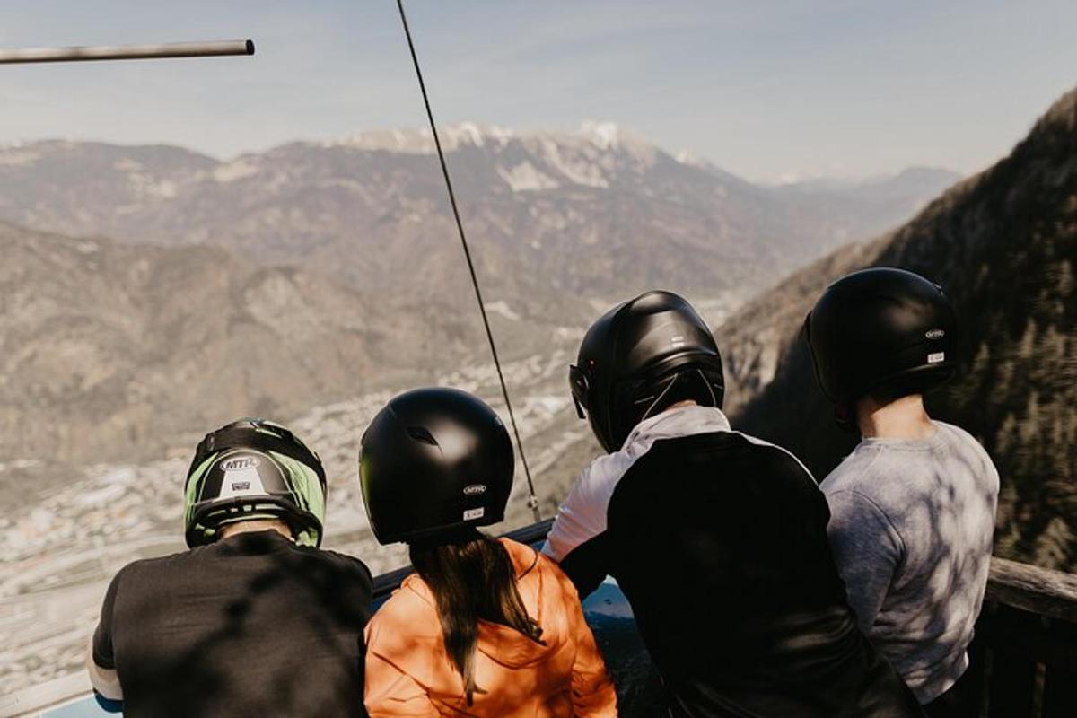 a group of people wearing helmets looking at the mountains