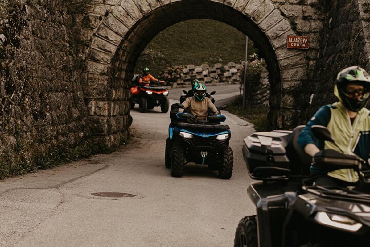 a group of people riding on atvs down a road