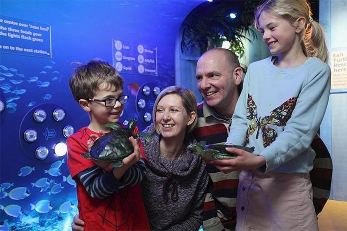 a group of people standing in front of a exhibit