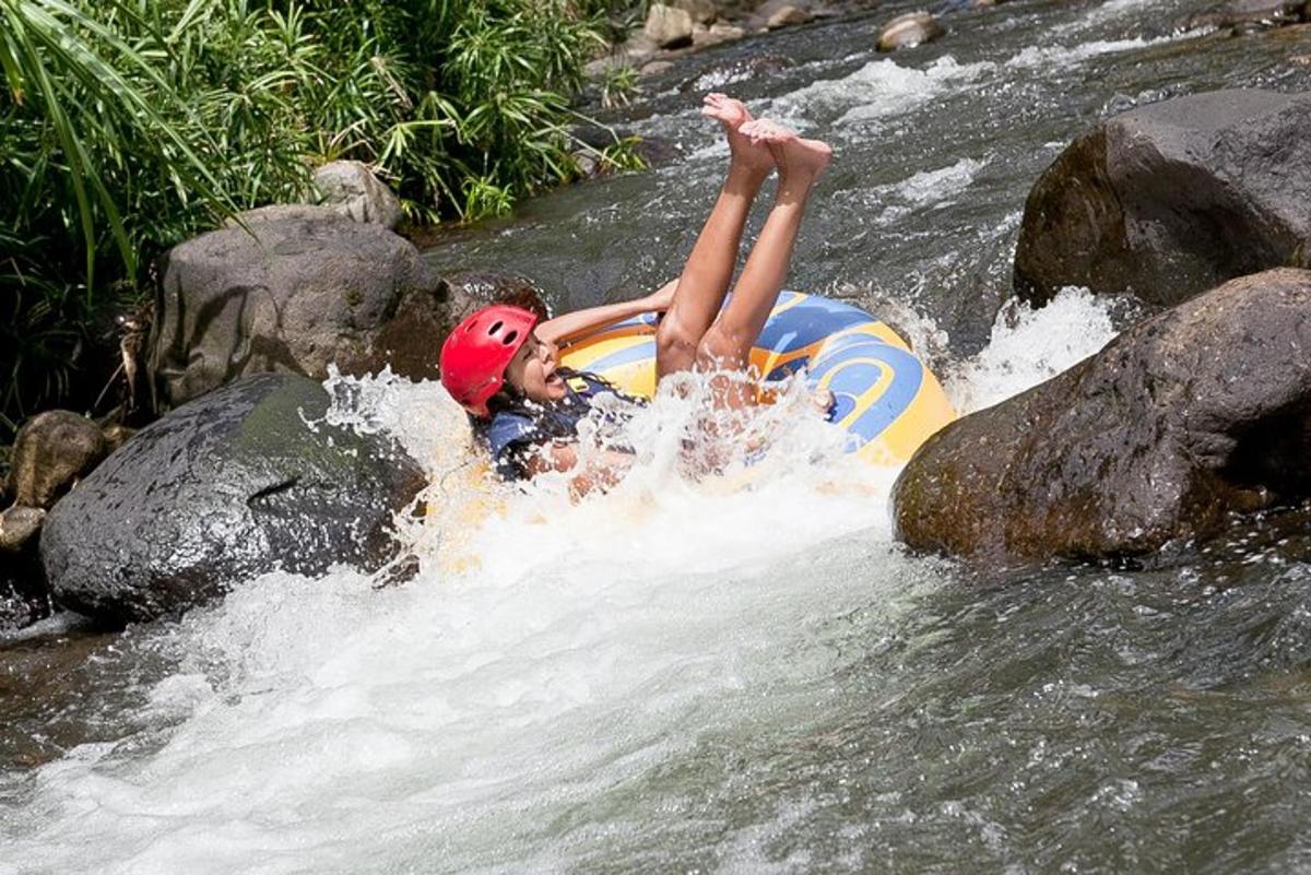 a person is laying on a raft in a river
