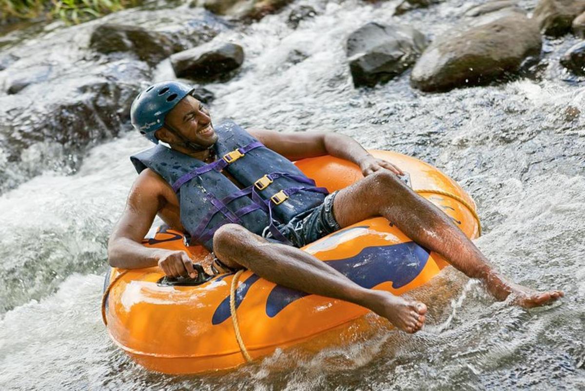 a man sitting on an orange raft in a river