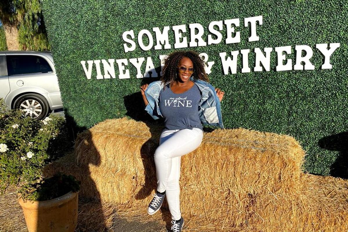a woman sitting on a hay bale