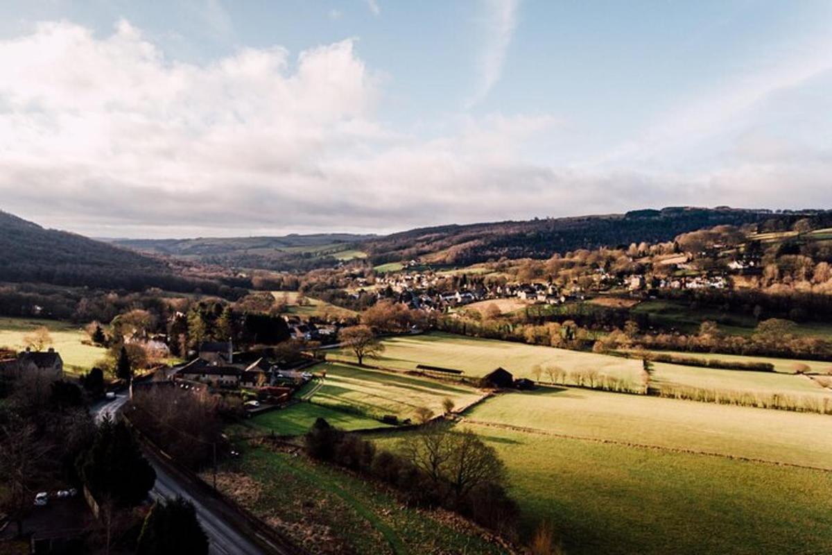 a view of a small town in a green field