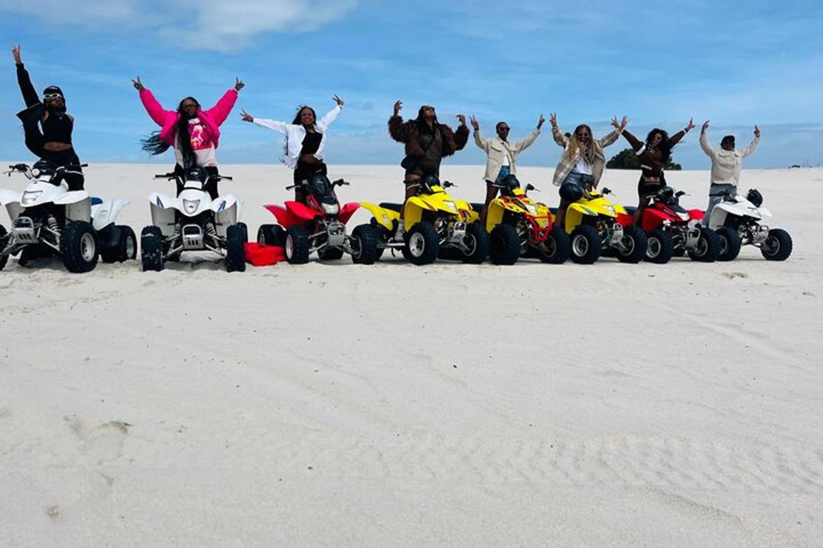 a group of people standing on motorcycles on the beach