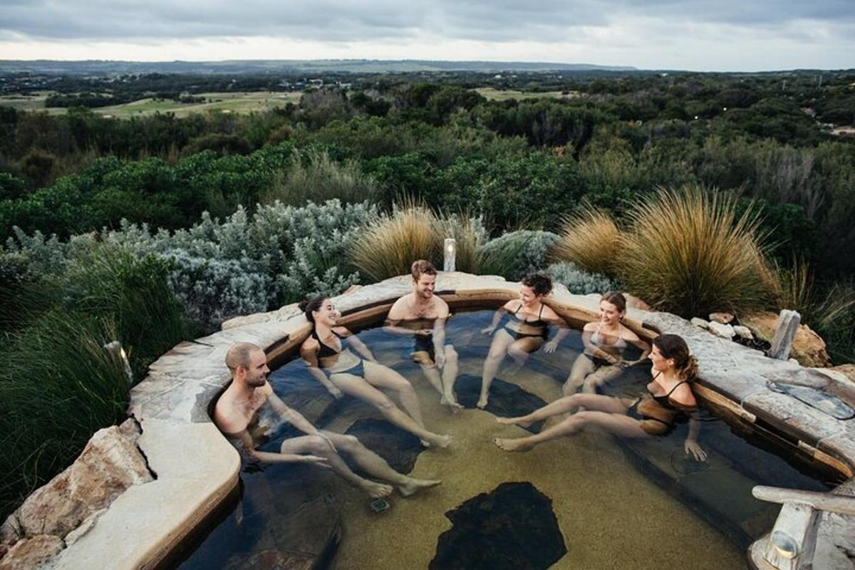 a group of people sitting in a swimming pool