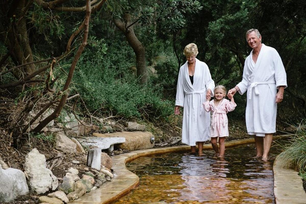 two adults and a little girl standing in the water