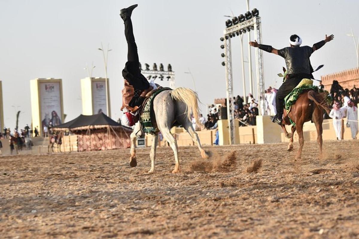 a man on a horse is performing a trick