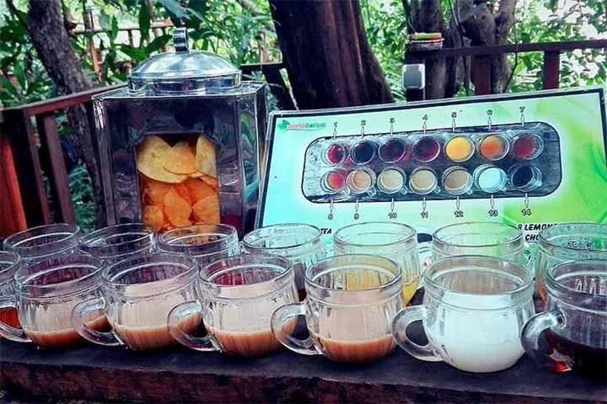 a table with many cups of food and a blender