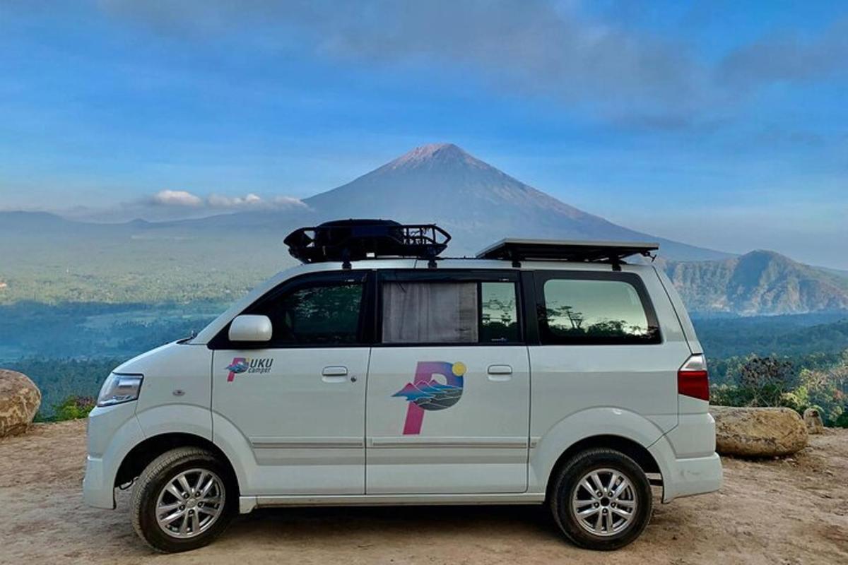a white van parked in front of a mountain