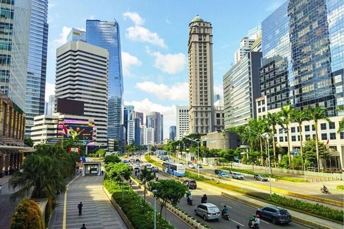 a busy city street with cars and buildings