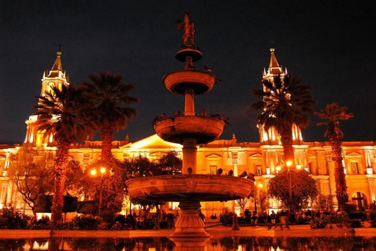 un grande edificio con una fontana di fronte