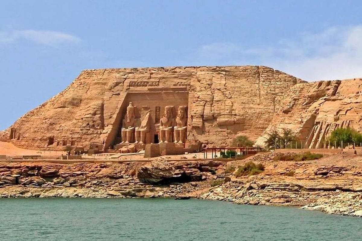 an ancient building on the side of a cliff