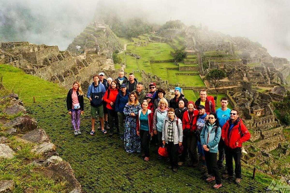 a group of people posing for a picture on a mountain