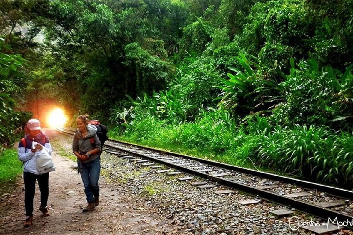due persone che camminano lungo i binari del treno