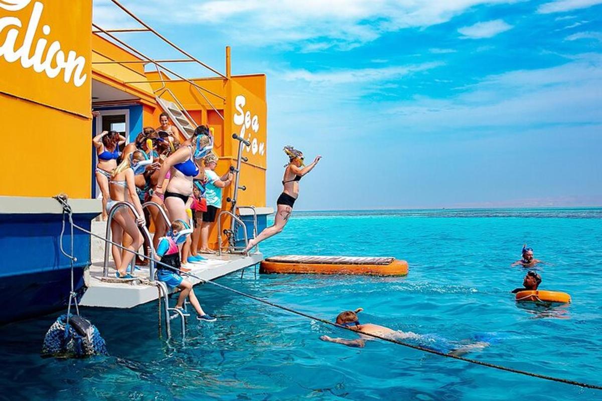 Un grupo de personas saltando al agua en un bote.