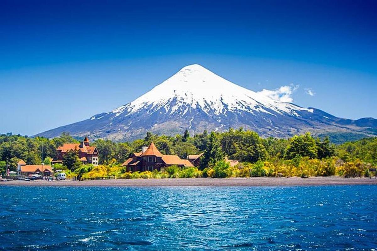 a mountain in the distance with a resort and a body of water