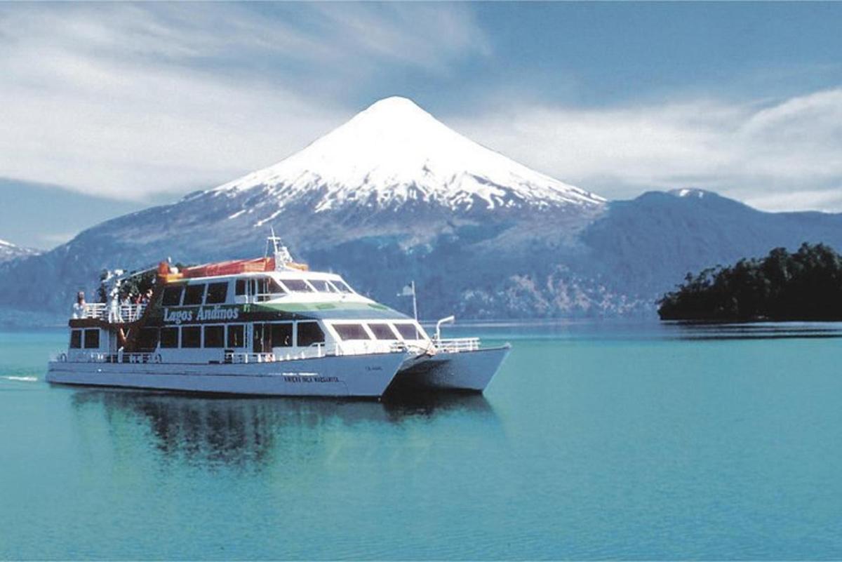 a boat in the water with a mountain in the background
