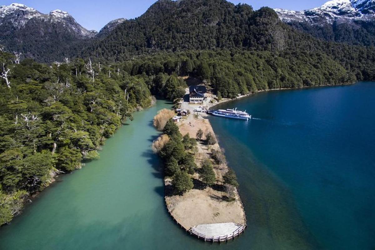 an aerial view of a lake with a boat in it