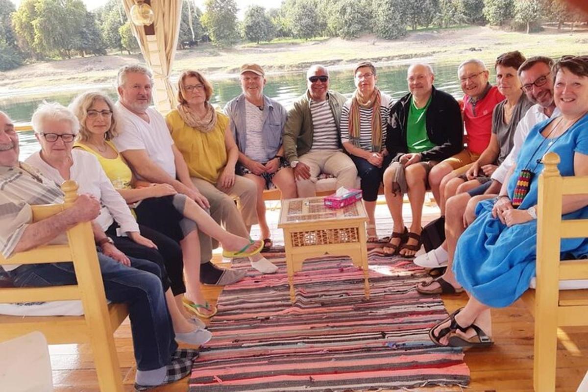 a group of people sitting in a group posing for a picture
