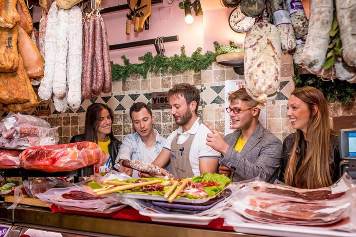 a group of people standing around a counter with food