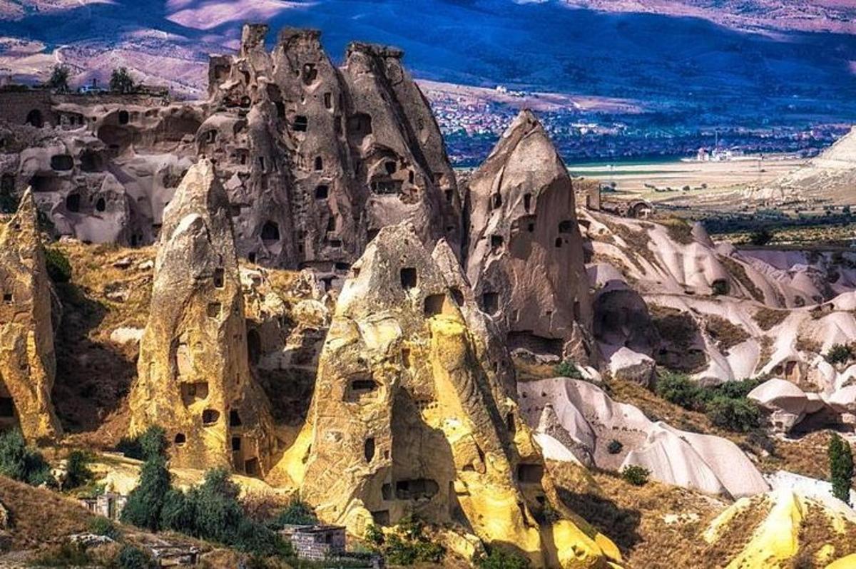 a view of a rocky mountain with dwellings on it