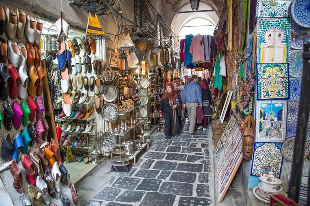 a group of people walking through a shop in a market