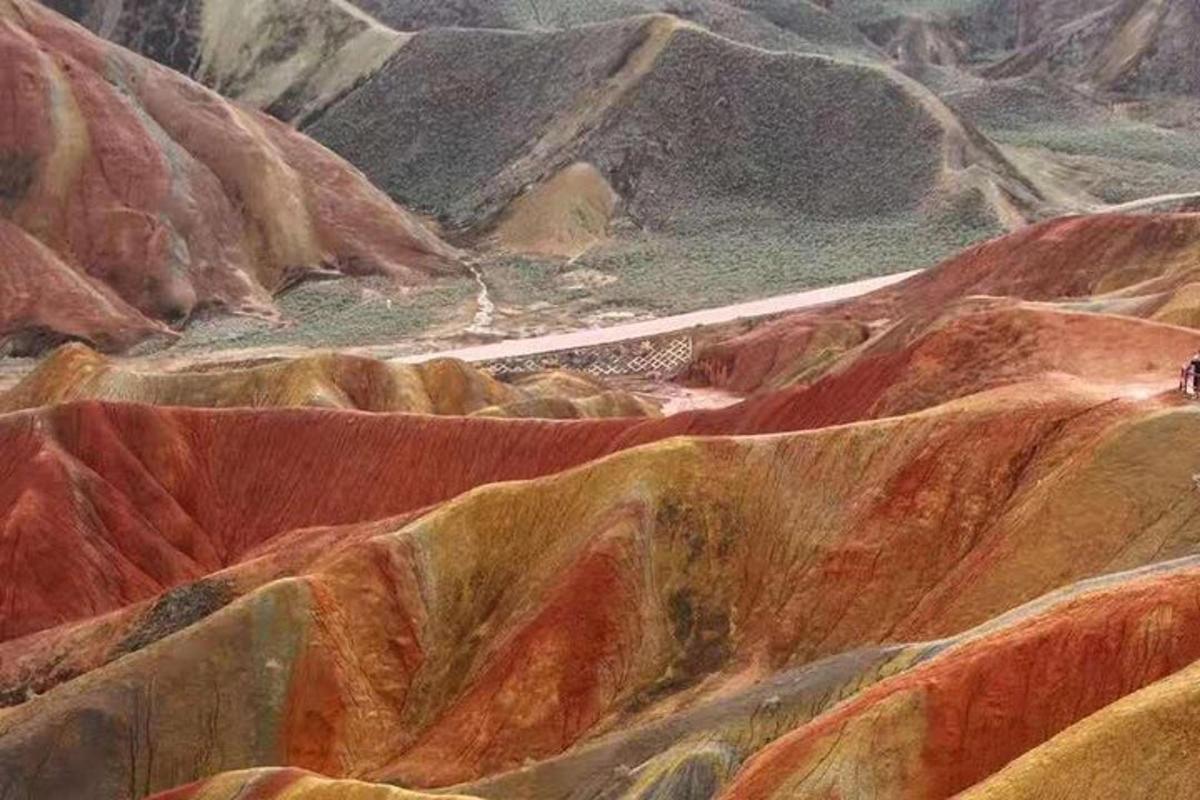a painting of a mountain with brown and red rocks