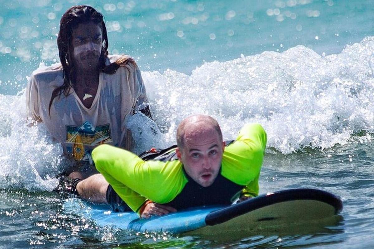 a woman and a man on a surfboard in the water