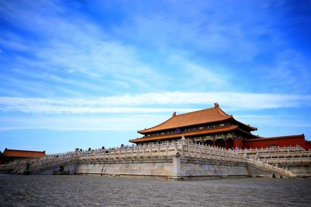 a large building with a red roof on the water