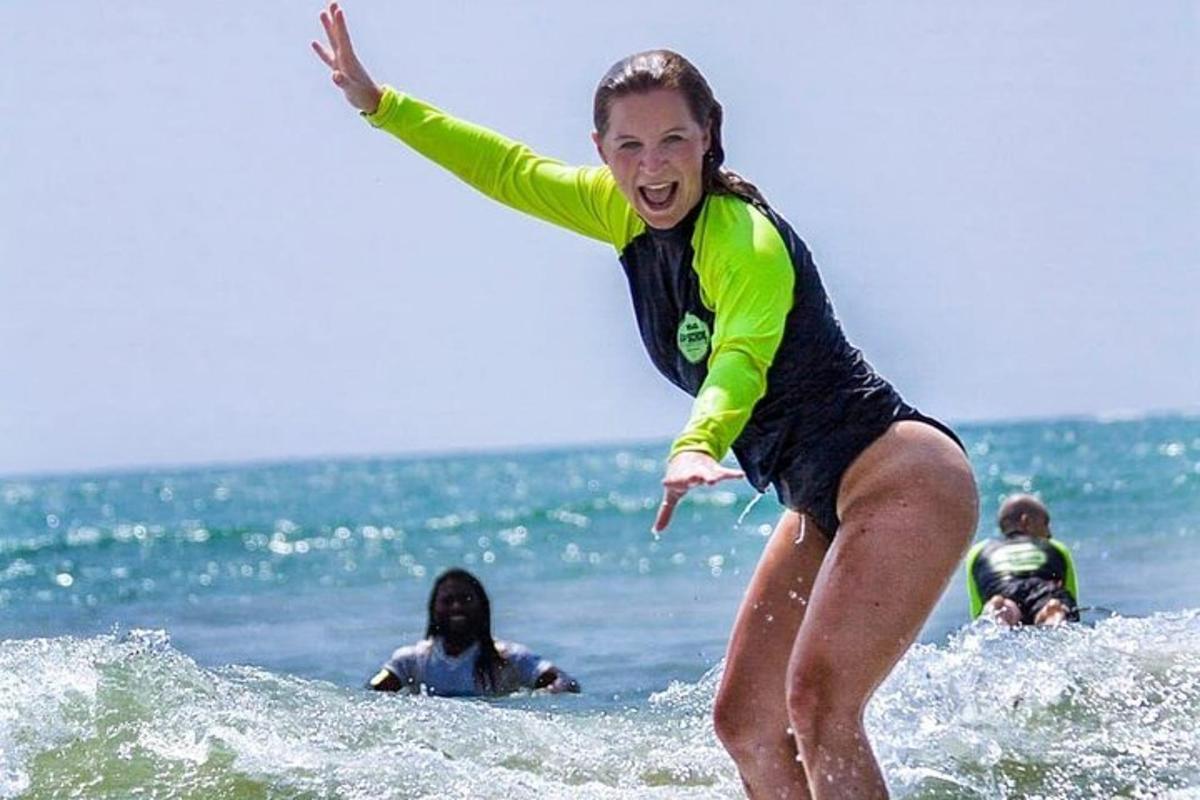a woman riding a wave on a surfboard in the ocean