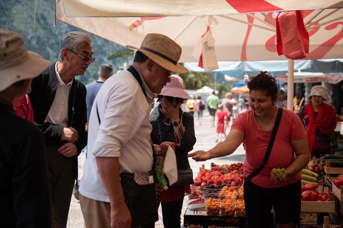 a group of people standing at a farmers market
