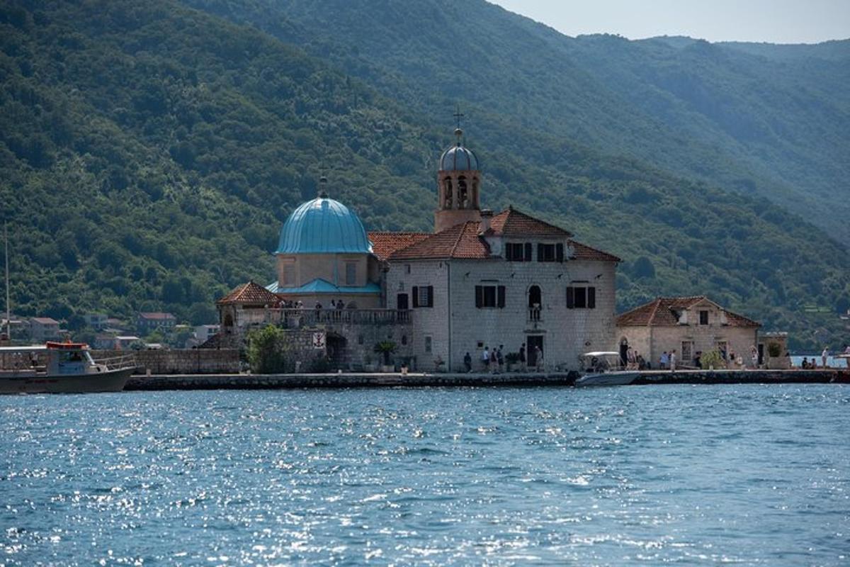 a building with a blue dome on top of a body of water