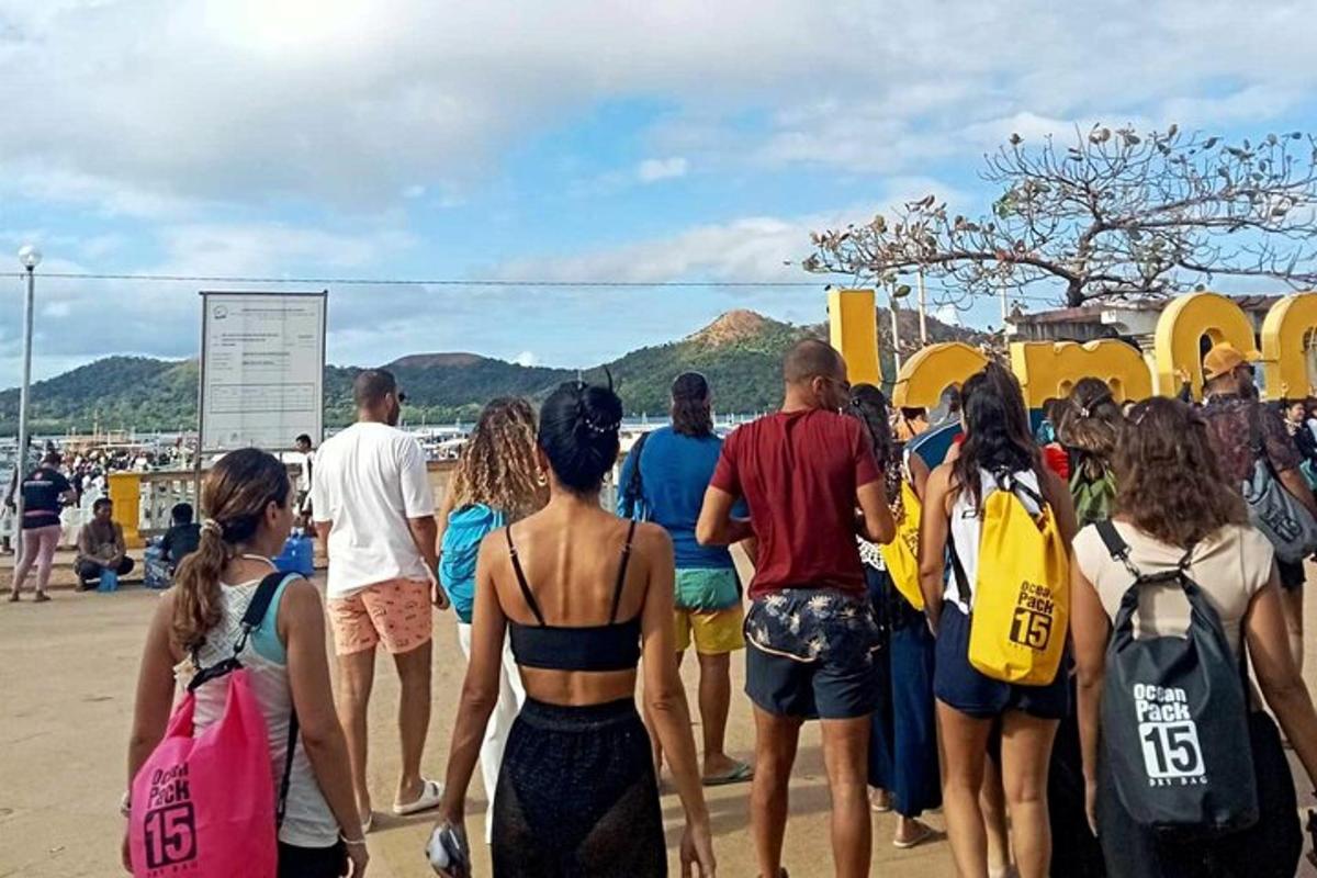 a group of people walking on the beach