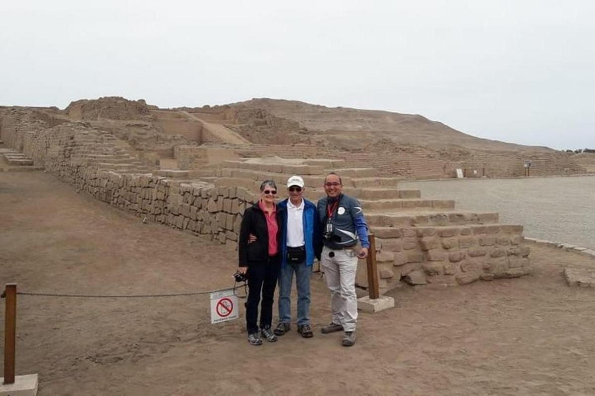 a group of people standing in front of a pyramid