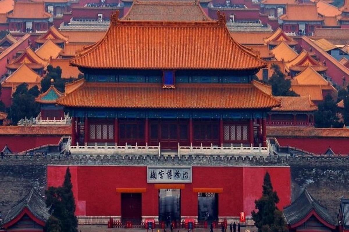 a chinese building with a red roof in a city