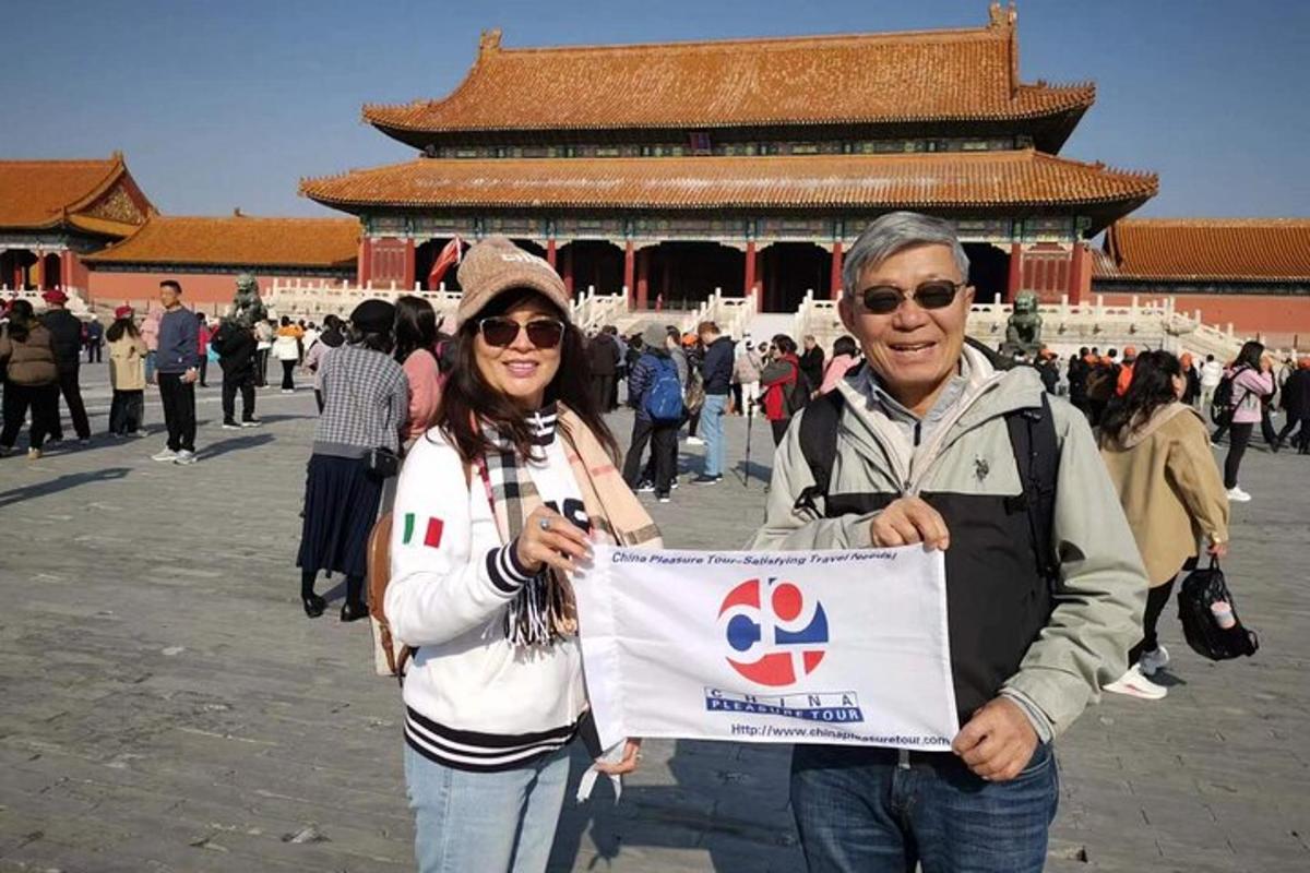 two people holding a sign in front of a building