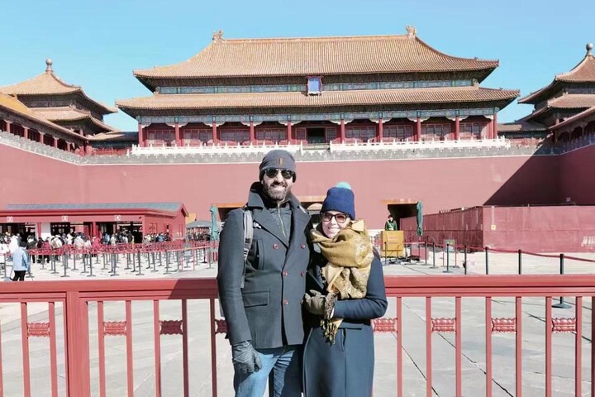 a man and a woman standing in front of a building